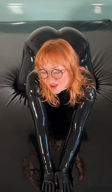 Oiled Chubby Redhead in Latex